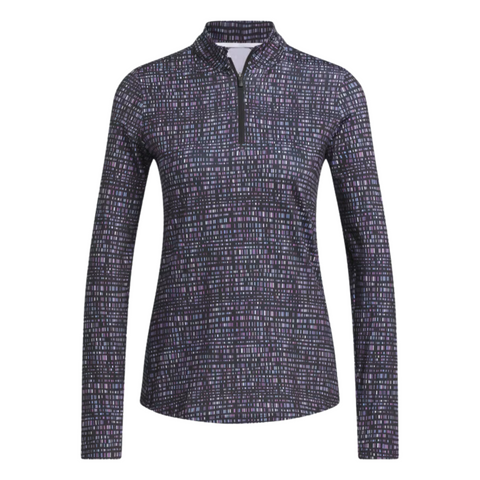 The Adidas Ultimate365 Women's Long Sleeve Golf Shirt in Black Noir features a grid-like abstract pattern in shades of purple, blue, and white on a black background, with a zippered collar and long sleeves.