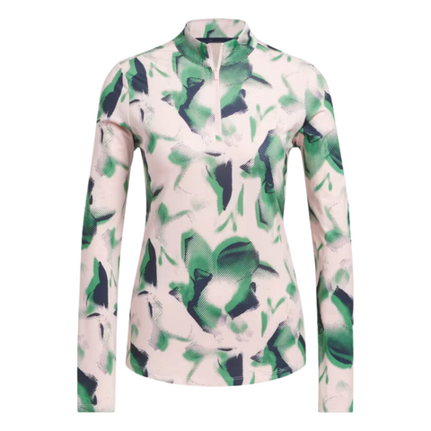 Adidas Ultimate365 Women's Long Sleeve Golf Shirt in Sandy Pink features an abstract green and navy print on a light pink base. The shirt has a mock neck and a half-zip front. It is designed for a relaxed fit with full-length sleeves.