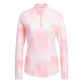 The Adidas Ultimate365 Women's Long Sleeve Golf Shirt in White Pink features a soft pink and white gradient pattern, with a zippered collar and long sleeves.