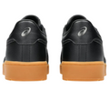 A pair of black Asics Japan S Mens Golf Shoes with light brown rubber soles, seen from the back with the Asics logo on each heel against a white background—perfect spikeless golf shoes for New Zealand courses.