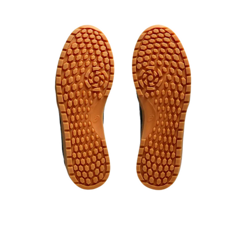 Two Asics Japan S Mens Golf Shoes by Asics are displayed sole-up on a white background, showing orange spikeless rubber soles with a honeycomb tread pattern.