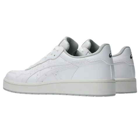 The Asics Japan S Womens Golf Shoes by Asics are white low-tops with light gray soles, retro golf-inspired design, subtle stitching, and mesh accents on the tongue and collar—shown angled to display side and heel views.