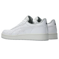 The Asics Japan S Women's Golf Shoes by Asics are white low-tops with light gray soles, retro golf-inspired design, subtle stitching, and mesh accents on the tongue and collar.