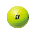 A bright yellow Bridgestone Extra Soft Golf Ball, featuring a black B and 1 on its dimpled surface, offers straight distance and is shown against a white background.