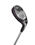 The Callaway 2023 Women's Big Bertha Reva Hybrid golf club, featuring a black, silver, and purple clubhead with prominent branding, is shown angled against a white background to highlight its easy launch design.