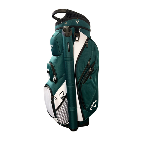 A Callaway 2025 Forrester Cart Bag in Forest Green/White stands upright on a white background, featuring multiple zippered pockets, a 14-way top, and a sturdy handle.