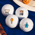 Four white Callaway 2025 Supersoft Grill Master Golf Balls by Callaway sit on a blue cloth, each featuring a unique barbecue-themed icon: grill, utensils with thermometer, chicken drumstick, and apron for ultimate soft feel.