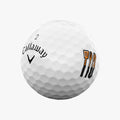 A white Callaway 2025 Supersoft Grill Master golf ball, numbered 2, features grill tool illustrations and logo. This limited edition offers the soft feel Callaway is known for on every swing.