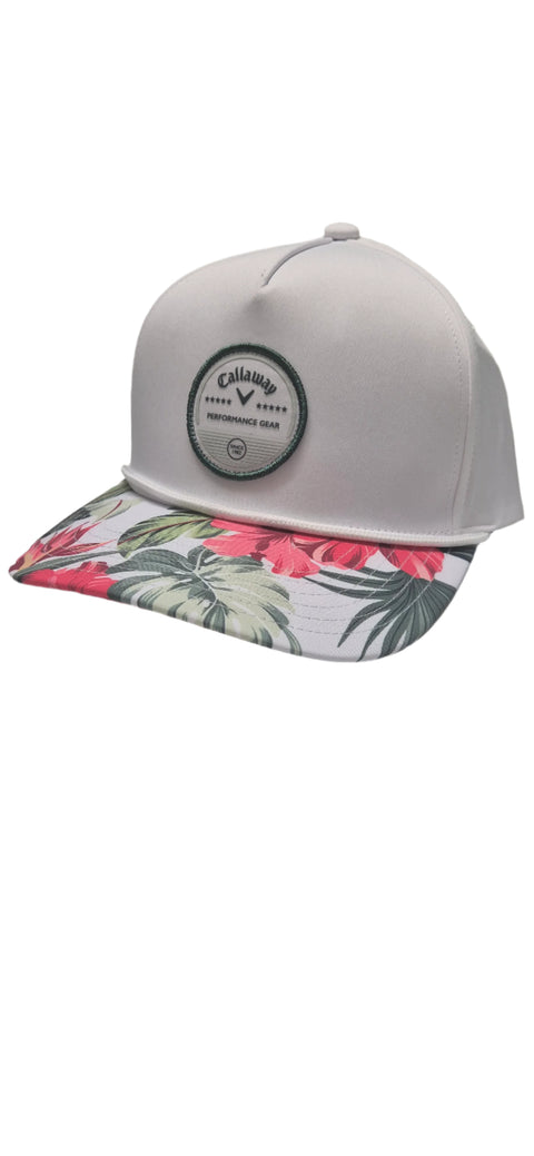 The Callaway Bogey Free Cap by Callaway is a light gray golf cap with a round front logo patch and a flat brim that features a vibrant tropical floral pattern in pink, green, and red.