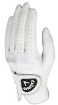 The Callaway Women's Dawn Patrol Golf Glove in white features premium leather, ventilation holes, and a black logo on the adjustable strap, shown upright with slightly curved fingers.