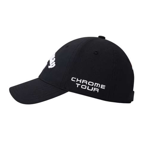 The Callaway Elyte Tour Authentic Performance Pro Hat in black features white embroidered CHROME TOUR text on the side and a front logo. This Callaway hat uses moisture-wicking fabric for all-day comfort on the golf course. Shown from a side angle.