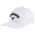 The Callaway Performance Pro Hat is a white golf hat with a curved brim, featuring the black embroidered Callaway logo and checkmark on the front. Its moisture-wicking fabric keeps you cool and comfortable on the course.