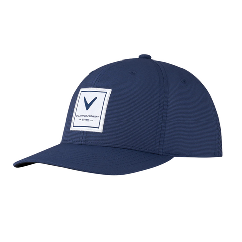 The Callaway Rutherford Cap is a navy blue golf hat with a curved brim, featuring a square white patch with a black V logo—ideal for any golf cap NZ collection.
