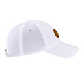 The Callaway Women’s Heritage Twill Golf Cap, shown in white with a curved brim, features a brown circular front patch, ventilation eyelets, and an adjustable back strap for fit.