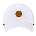 The Callaway Women’s Heritage Twill Golf Cap is white with a round brown leather patch, displaying the black Callaway logo and chevron. It features sun protection and an adjustable fit for comfort on the course.
