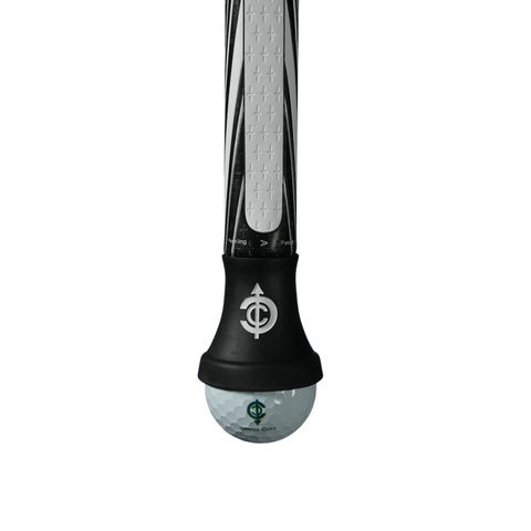 Close-up of the Center Cutt A Competition Putter Grip | White/Black by Center Cutt, featuring a crosshatch pattern and a translucent end knob with an embedded golf ball, both marked with a green logo for a unique touch.