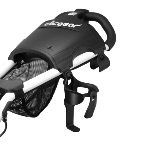 A close-up of the Clicgear Cup Holder, a black and white accessory from Clicgear, attached to a push cart with mesh storage and handle—an essential golf drink holder for any golfer.