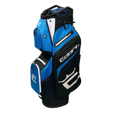 The Cobra 2025 Signature Cart Bag in Electric Blue/White/Black features a 14-way top, multiple zippered pockets, padded areas, and a large logo—combining style and function for golfers.