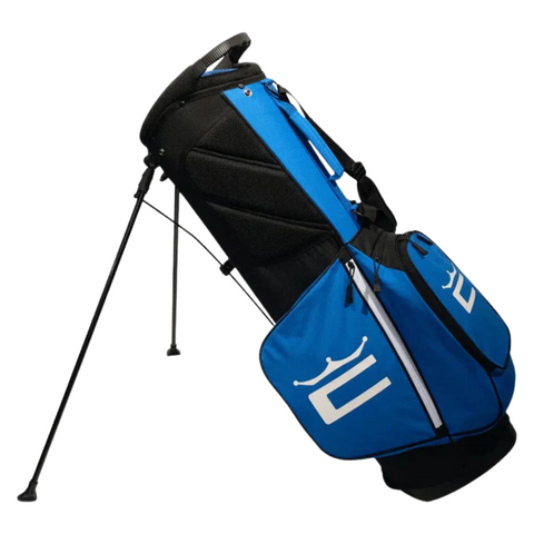 The Cobra 2025 Signature Stand Bag in electric blue, white, and black stands on tripod legs and features zippered pockets, a padded shoulder strap, and a bold Cobra logo for stylish convenience.