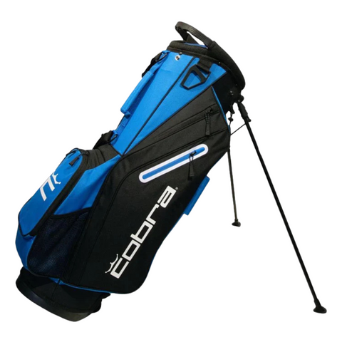 The Cobra 2025 Signature Stand Bag by Cobra, in electric blue, white, and black, stands upright on its legs. Lightweight and practical, it features multiple pockets and displays the white Cobra logo against a clean background.