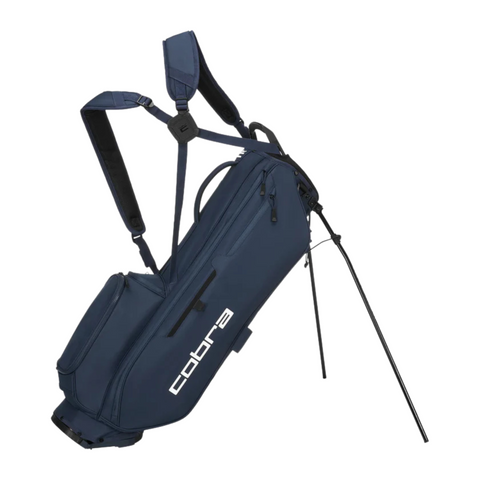 The Cobra 2025 Ultralite Pro Stand Bag in navy has dual shoulder straps, multiple zippered pockets, two stand legs, and "cobra" printed in white—lightweight and ideal for walking golfers.