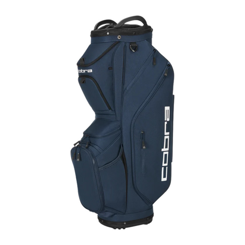 The Cobra Ultralite Pro Cart Bag 2025 by Cobra is a navy blue, lightweight golf cart bag with multiple zippered compartments, white Cobra branding, a cylindrical 14-way top for clubs, and sturdy carrying handles.
