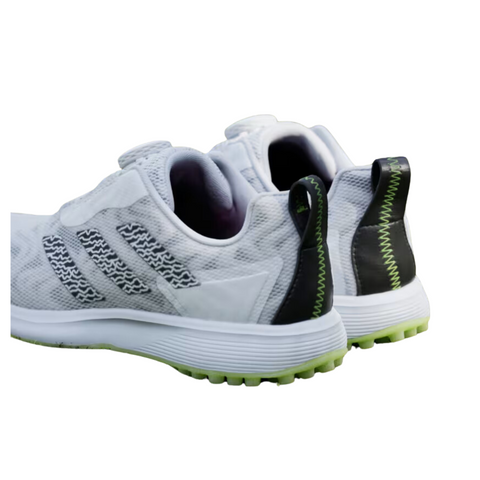 Back view of the Adidas Codechaos BOA junior golf shoes, featuring a black heel with lime green stitching and a pull tab for easy wear. The white mesh upper is accented with black details and sits on a lime green spikeless outsole designed for traction.