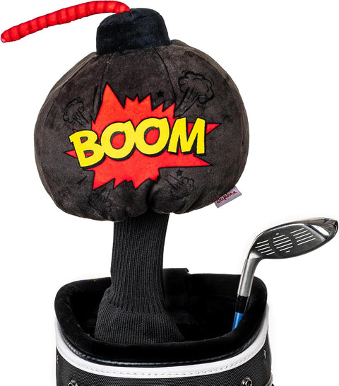 A plush bomb-shaped driver headcover with a red fuse and bold BOOM lettering adds playful flair to a golf bag next to an iron and classic Daphnes Animal Golf Headcovers by Daphne.