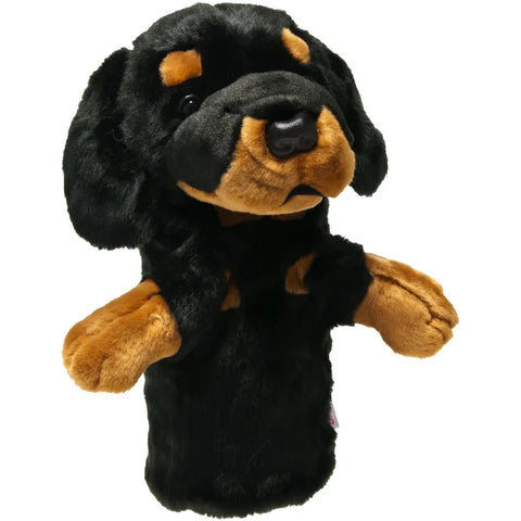 A soft, plush hand puppet shaped like a black and brown dog with floppy ears and expressive eyes, inspired by Daphnes Animal Golf Headcovers from the Daphne brand—ideal for fans of charming animal headcovers.