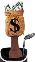 A golf bag holds a driver with a Daphnes Animal Golf Headcover and a brown club headcover shaped like a money bag with a dollar sign, stuffed with imitation dollar bills.