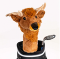 A Daphnes Animal Golf Headcover by Daphne, featuring a plush deer design with antlers, sits on a golf bag beside a metal club on a plain white background.