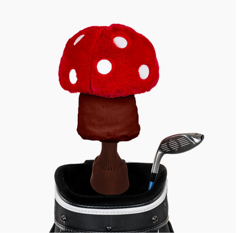 A plush red mushroom headcover with white spots from Daphne’s Animal Golf Headcovers sits on a club in a black and white bag next to another exposed club, all against a white background.