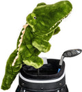 A plush green alligator golf driver headcover from Daphne’s Animal Golf Headcovers by Daphne sits on a club in a golf bag next to a metal driver, set against a white background.