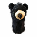 Daphne's Black Bear golf driver headcover, front three-quarter view showing the black plush coat, rounded ears, tan muzzle and long black protective sleeve on a clean white background