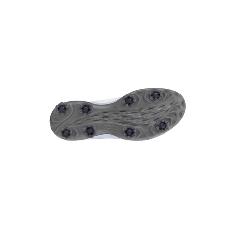 The image shows the gray sole of the ECCO Biom Tour Mens Golf Shoes by Ecco, featuring six black cleats in a symmetrical pattern, a textured grip design, and the brand name “ecco” displayed at the center. The shoe is also waterproof.