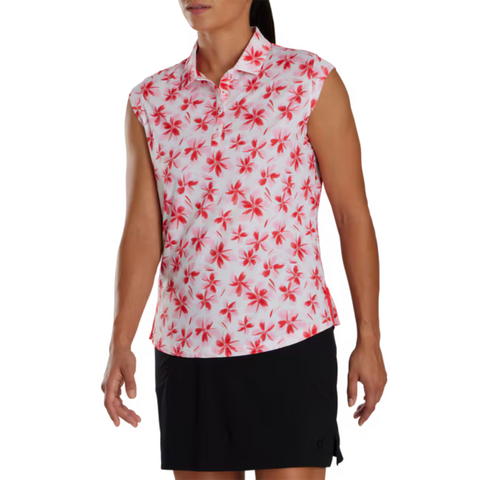 Front view of a sleeveless FootJoy golf shirt with a red and pink floral pattern on a white background. Paired with a black skirt, the shirt showcases a bold, eye-catching design perfect for summer golfing.
