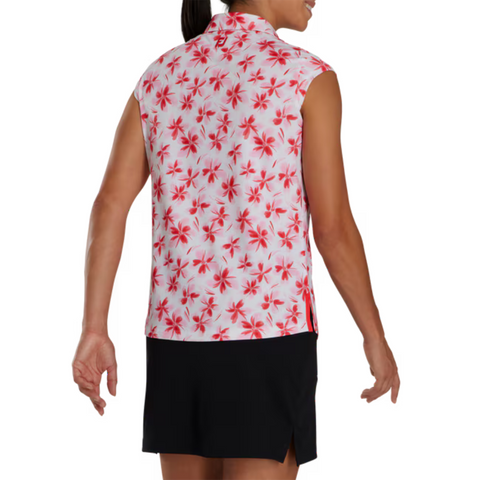 Back view of a sleeveless FootJoy golf shirt with a red and pink floral pattern on a white background. Paired with a black skirt, the shirt showcases a bold, eye-catching design perfect for summer golfing.