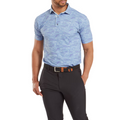 Model wearing the FootJoy Golf Doodle Polo in storm blue with abstract white and purple doodles, paired with dark pants. The polo features a button-down collar and a fitted design.
