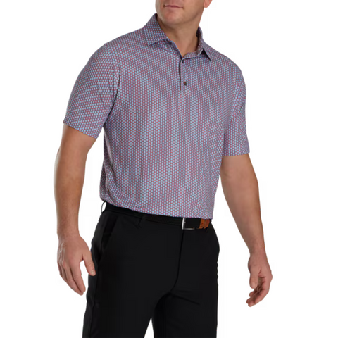 FootJoy Scallop Shell Foulard Polo worn by a model. The polo features a purple and pink geometric pattern, short sleeves, and a classic collar with button placket. Tailored for a comfortable fit, ideal for golf performance.