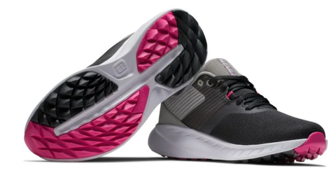A pair of FootJoy 2023 Women's Flex Golf Shoes in black with gray accents and white midsoles. One shoe is upright, the other displays a black and bright pink textured outsole.