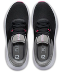 A pair of FootJoy 2023 Women's Flex Golf Shoes in black, seen from above with white soles, gray tongues, and pink accents. Insoles show FLEX and the FJ logo, representing the FootJoy brand.