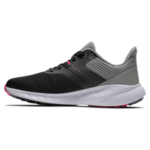 The FootJoy Flex Women’s Golf Shoes by FootJoy feature a black and gray design with a white sole and pink outsole accents, shown in side profile against a white background—ideal for fans of lightweight golf shoe style.