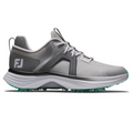 The FootJoy Hyperflex Women’s Golf Shoes feature a gray and white design with teal accents, breathable mesh, textured sole, laces, and FJ logo—offering lightweight comfort and modern style for golfers.