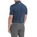 A man is seen from behind wearing the FootJoy Men's Flower Bud Foulard Lisle Polo in navy and gray pants. This short-sleeve polo features ProDry performance fabric and a small white FootJoy logo near the collar on the upper back.