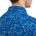 A close-up of a person wearing the FootJoy Men's Golf Course Doodle Polo in Deep Blue, showcasing abstract and cursive patterns on the back and collar. Only the lower half of their face is visible.