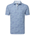 The FootJoy Men's Golf Course Doodle Polo is a light blue, short sleeve golf shirt with a collar and abstract white and purple line pattern. It features moisture-wicking, performance stretch, and an FJ logo on the inside collar.