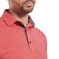 A man models the FootJoy Men's Heather Lisle Polo in Hibiscus, featuring a contrasting patterned inner collar. The cropped photo shows just his lower face, neck, and upper chest in this stylish, lightweight stretch polo by FootJoy.