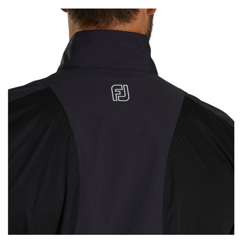 Close-up of the back of a person wearing the FootJoy Men’s HydroLite X Rain Jacket with a high collar. The white FJ logo appears at the upper center, highlighting this premium waterproof golf jacket from FootJoy.