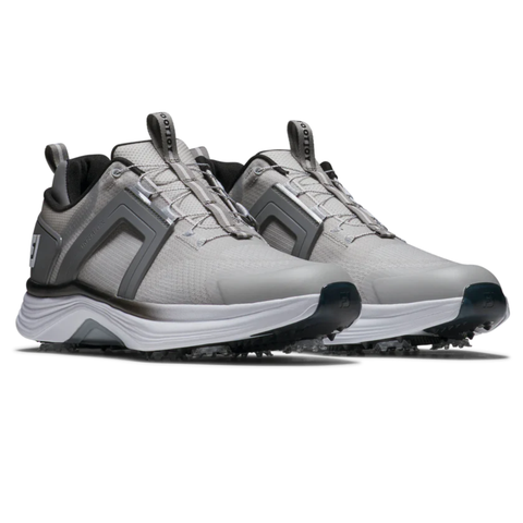 A pair of FootJoy Men's Hyperflex BOA Golf Shoes in grey/white, featuring black and white accents, thick soles with textured grip, and pull tabs on tongue and heel, are positioned slightly facing right.