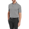 Smiling man wearing a FootJoy Mens Micro Feeder Stripe Lisle Polo in Black/Grey, tucked into black pants with a black belt, standing with one hand in his pocket.